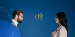 A man and woman staring different faces of an apple. 