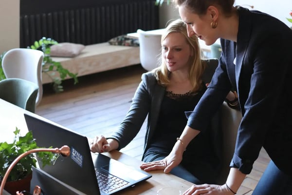 Sales manager helping a sales rep with her task