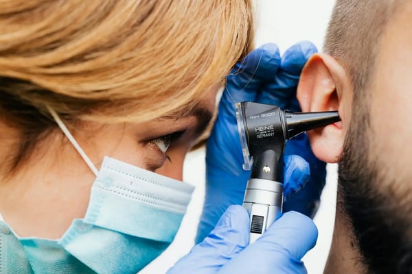 Doctor checking for ear infection