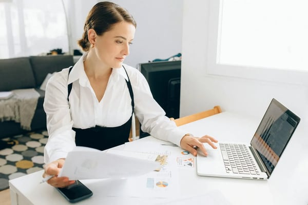 Sales employee taking notes from her coaching program